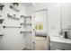 Bright bathroom with modern fixtures, floating shelves and open view to bedroom at 1518 Cheyenne Ne St, St Petersburg, FL 33703