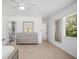 Spacious bedroom featuring light wood flooring, dresser, and ensuite bath at 1518 Cheyenne Ne St, St Petersburg, FL 33703