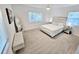Well-lit bedroom featuring a bed, mirror, and bench at 1518 Cheyenne Ne St, St Petersburg, FL 33703