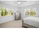 Bedroom with white walls, light wood floors, and lots of natural light from two windows at 1518 Cheyenne Ne St, St Petersburg, FL 33703