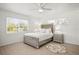 Cozy bedroom featuring a silver bed frame, neutral decor, and natural light from windows at 1518 Cheyenne Ne St, St Petersburg, FL 33703