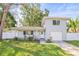 Charming two-story home featuring a well-maintained lawn, attached garage, and a cozy front porch at 1518 Cheyenne Ne St, St Petersburg, FL 33703