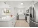 Modern kitchen with white cabinetry, stainless steel appliances, and a large quartz island at 1518 Cheyenne Ne St, St Petersburg, FL 33703