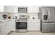 A bright kitchen featuring white cabinets, quartz countertops, and stainless steel appliances at 1518 Cheyenne Ne St, St Petersburg, FL 33703