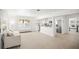 Spacious living room featuring white walls, tile flooring, and an open kitchen at 1518 Cheyenne Ne St, St Petersburg, FL 33703