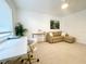 Contemporary living room featuring a sofa, accent chair, and bright window at 1518 Cheyenne Ne St, St Petersburg, FL 33703