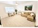 Bright living room with a sofa, desk, modern lighting, and large picture window at 1518 Cheyenne Ne St, St Petersburg, FL 33703