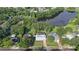 Aerial view of the community, highlighting the pool and landscaping along the lakeside at 15316 Winding Creek Dr, Tampa, FL 33613