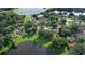 Aerial view of the residential community, showcasing lush greenery, mature trees, and serene lake views at 15316 Winding Creek Dr, Tampa, FL 33613