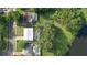 Bird's eye view of the home showcasing lush landscaping, screened-in pool and proximity to the lake at 15316 Winding Creek Dr, Tampa, FL 33613