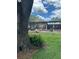 Large backyard with a screened-in patio, ideal for outdoor entertaining and enjoying the serene views at 15316 Winding Creek Dr, Tampa, FL 33613