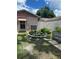 Landscaped backyard featuring a charming fountain, garden beds and manicured lawn at 15316 Winding Creek Dr, Tampa, FL 33613