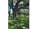 Backyard featuring a cozy wooden porch swing, stone pavers, and serene landscaping, perfect for relaxing outdoors at 15316 Winding Creek Dr, Tampa, FL 33613