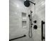 Modern bathroom shower showcasing white subway tiles and sleek black fixtures at 15316 Winding Creek Dr, Tampa, FL 33613