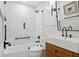 Bathroom with a glass-enclosed tub shower, modern lighting, and wood vanity at 15316 Winding Creek Dr, Tampa, FL 33613