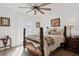 Bedroom with dark wood floors and a large window dressed with wood shutters at 15316 Winding Creek Dr, Tampa, FL 33613