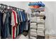 Organized closet with hanging clothes and neatly stacked towels and accessories at 15316 Winding Creek Dr, Tampa, FL 33613