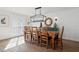 Dining area features shiplap wall, rustic wood table, modern chandelier at 15316 Winding Creek Dr, Tampa, FL 33613