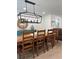 Dining room with a rustic wood table, modern light fixture, and decorative accents at 15316 Winding Creek Dr, Tampa, FL 33613