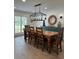 Charming dining room featuring a rustic table, stylish lighting, and shiplap walls at 15316 Winding Creek Dr, Tampa, FL 33613