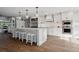Modern white kitchen with large island, stainless steel appliances, and pendant lighting at 15316 Winding Creek Dr, Tampa, FL 33613