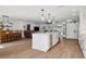 Open kitchen with island overlooking dining and living areas, wood flooring at 15316 Winding Creek Dr, Tampa, FL 33613