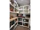 Walk-in pantry featuring open white shelves, wood countertops, and organized storage at 15316 Winding Creek Dr, Tampa, FL 33613