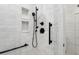 Close up of the shower with marble tiling and matte black fixtures at 15316 Winding Creek Dr, Tampa, FL 33613