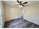 Neutral bedroom showcasing wood-look floors and a ceiling fan at 1565 S Martin Luther King Jr Ave, Clearwater, FL 33756