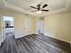 Spacious bedroom with tray ceiling, ceiling fan, and convenient access to the ensuite bathroom at 1565 S Martin Luther King Jr Ave, Clearwater, FL 33756