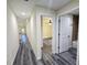Hallway featuring wood-look floors and views to a bedroom and bath at 1565 S Martin Luther King Jr Ave, Clearwater, FL 33756