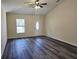 Bright living room featuring vaulted ceiling, ceiling fan and attractive wood-look flooring at 1565 S Martin Luther King Jr Ave, Clearwater, FL 33756