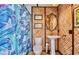 Tropical-themed bathroom with leafy shower curtain, woven walls, and pedestal sink at 1592 Cumberland E Ct, Palm Harbor, FL 34683