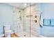 Modern bathroom featuring tiled shower, frameless glass door, and wooden-look tile floors at 1592 Cumberland E Ct, Palm Harbor, FL 34683