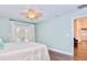 Light-filled bedroom featuring hardwood floors and french doors leading to pool area at 1592 Cumberland E Ct, Palm Harbor, FL 34683