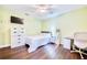Bedroom with a ceiling fan, wood floors, and light green walls with desk at 1592 Cumberland E Ct, Palm Harbor, FL 34683