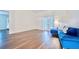 Bright bedroom featuring french doors leading to pool, hardwood floors, and light-blue walls at 1592 Cumberland E Ct, Palm Harbor, FL 34683