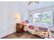 Comfortable bedroom with a wooden nightstand and bright multi-color bedspread at 1592 Cumberland E Ct, Palm Harbor, FL 34683