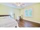 Bedroom with a ceiling fan, wood floors, and light green walls at 1592 Cumberland E Ct, Palm Harbor, FL 34683