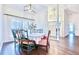 Bright dining room with hardwood floors, large windows, and decorative light fixture at 1592 Cumberland E Ct, Palm Harbor, FL 34683