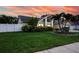 Well-maintained home featuring lush landscaping, mature trees, and a sprawling green lawn at 1592 Cumberland E Ct, Palm Harbor, FL 34683