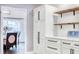 Kitchen area with custom white cabinetry, storage, and modern countertops at 1592 Cumberland E Ct, Palm Harbor, FL 34683