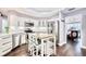 Bright kitchen with white cabinetry, stainless steel appliances, and a butcher block island with seating at 1592 Cumberland E Ct, Palm Harbor, FL 34683