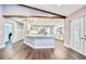 Bright, white kitchen featuring a center island, stainless steel appliances, and modern lighting at 1592 Cumberland E Ct, Palm Harbor, FL 34683