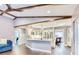 Open concept home featuring a fireplace, kitchen, living room, and dark hardwood floors at 1592 Cumberland E Ct, Palm Harbor, FL 34683