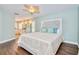 Spacious main bedroom with hardwood floors, ceiling fan, and en suite bathroom at 1592 Cumberland E Ct, Palm Harbor, FL 34683