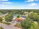 Aerial view of charming single-Gathering home featuring a brick driveway, mature trees, and proximity to a serene lake at 1710 Townsend St, Clearwater, FL 33755