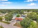 Aerial view of charming single-Gathering home featuring a brick driveway, mature trees, and proximity to a serene lake at 1710 Townsend St, Clearwater, FL 33755