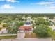 Aerial view of home and community surrounded by lush trees and a lake at 1710 Townsend St, Clearwater, FL 33755