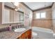 A cozy bathroom with a granite vanity, decorative mirrors, and a tiled bathtub at 1710 Townsend St, Clearwater, FL 33755